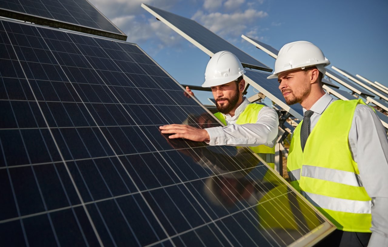 technicians-examining-solar-panels